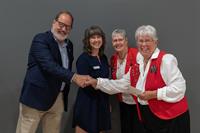 Board members Karl Stegemann and Jacquie Brand present the Kamloops Old Time Fiddlers with a grant.