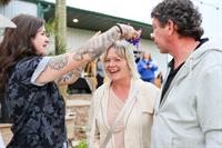 Executive Director, Abbey, crowning the Wine-D Down trivia winner, in June 2025.