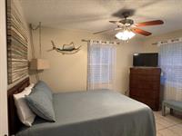 You can almost feel the ocean breeze in this cozy master bedroom! 