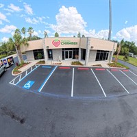 Completed parking lot striping at Plant City Chamber of Commerce with fresh ADA markings, white stall lines, and red curb stops