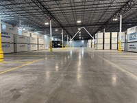 Yellow safety floor markings inside 1-800-PACK-RAT warehouse facility in Tampa