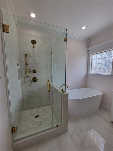 Renovated primary bathroom. Shower and free standing tub pictured. 