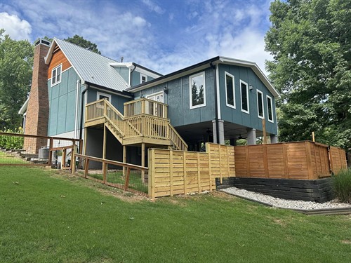 Large speakeasy style bar added to the rear of existing home suspended in the air on pillars. Includes new laundry/pantry space and half bathroom with a full bar and a gas fireplace. Addition hidden behind a Murphy door bookcase. 