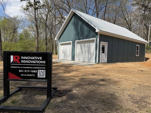 Detached four car garage complete with two bay doors and finished attic storage space. Roof, siding, and trim all match existing home on property. 