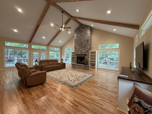 Large vaulted sunroom addition to existing home with gas fireplace and hardwood floors. Existing home received full renovation inside and out. 