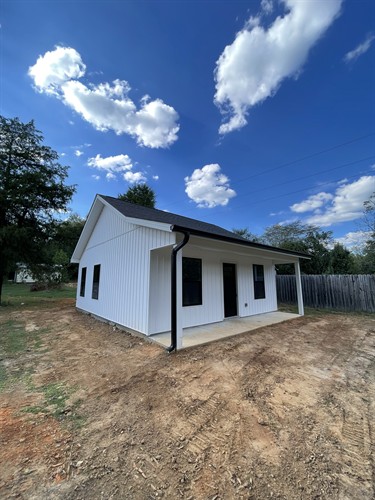 Tiny house or accessory dwelling unit (ADU) created for a mother in-laws quarters on existing property. Includes one bedroom, full kitchen, walk-in closet, and full bathroom with laundry room in less than 700 sq ft.