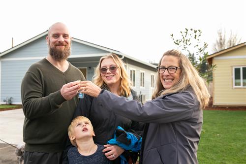 Family receiving keys for home at Johnson Village