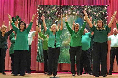 Gallery Image Cast_Members_in_hands_up_pose_-_Aurora_Singers_Luck_of_the_Irish_-_March_2023_Concert_-_photo_Becky_Toma.jpg