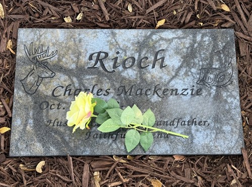 Flat granite marker featuring custom engraving and personalized artwork, designed to reflect a unique life and legacy.