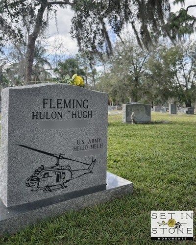 Custom granite monument featuring detailed engraving and personalized artwork to honor a life of service.