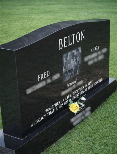 Custom-crafted granite monument with engraved portrait and lettering, designed to honor a lasting legacy.