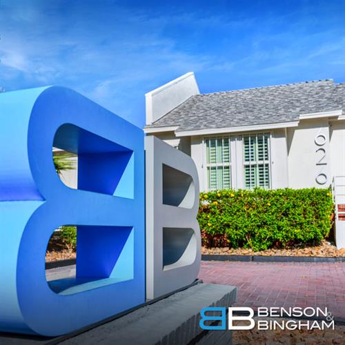 A blue Benson & Bingham Law Firm sign stands outside the Downtown office, marking their dedication to clients seeking personal injury representation.