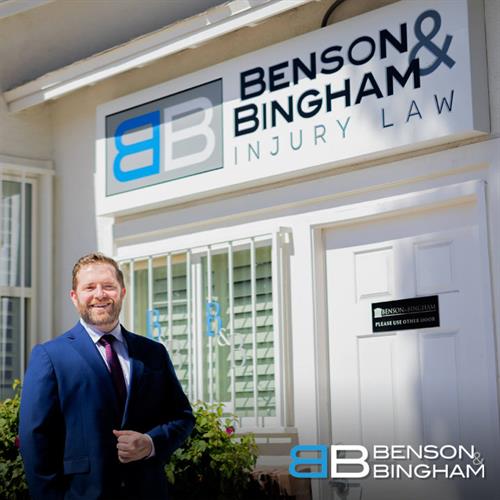 At the entrance of Benson & Bingham Law Firm in Downtown Las Vegas, attorney Jordan Kingsley greets clients seeking help with personal injury cases.