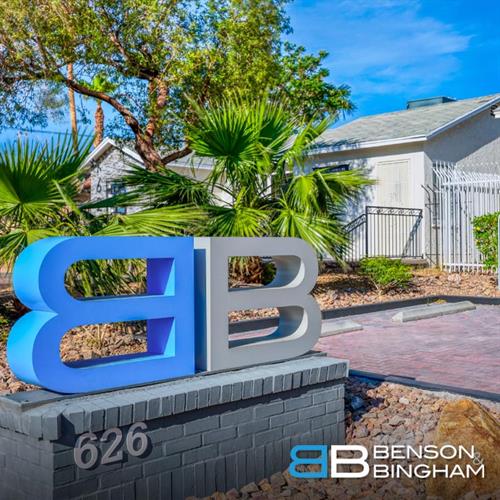 The Benson & Bingham Law Firm sign near the parking area reminds clients they’re in the right place for trusted help after a motorcycle accident.