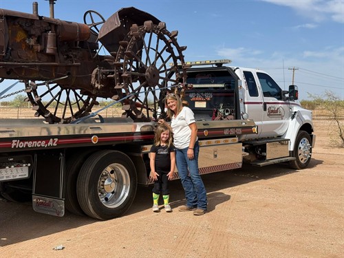 Stephanie 'Nana' and Brinlee moving an antique tractor for a local Family