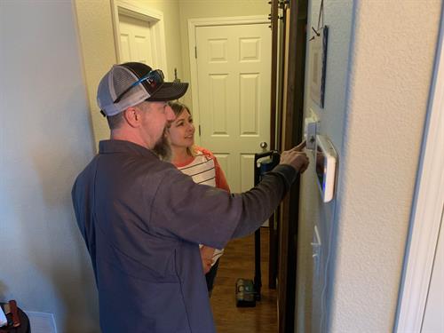 Kevin showing furnace winner new thermostat