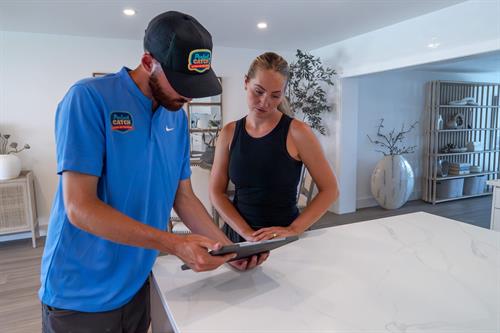 A Perfect Catch Electric technician reviews project details with a homeowner, ensuring clear communication and top-tier service from start to finish.