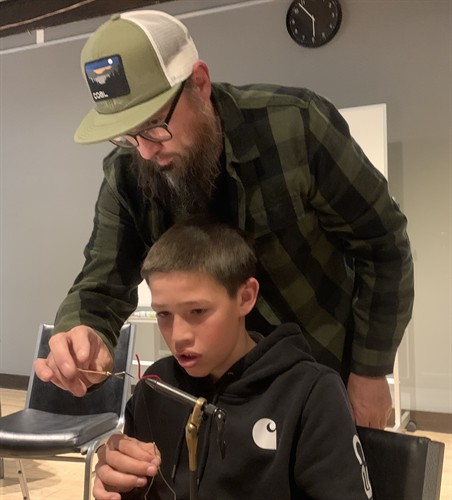 Jarett Coons helping Peter Charley Jr