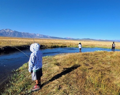 Kids fishing on the river
