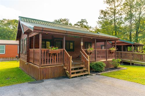 DELUXE CABINS: Our two bedroom deluxe cabins can accommodates up to 6 guests and includes a full size bed in the master bedroom, and bunk beds in the second bedroom, plus a sleeper sofa in the living room. 