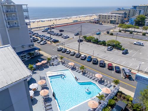 Aerial image of pool with the beach and boardwalk in the background Aerial image of pool with the beach and boardwalk in the background