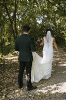 Bridge and Groom walk down the forest lounge path Bridge and Groom walk down the forest lounge path