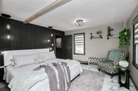 Lake Superior Suite — a spacious primary bedroom with private bath, fireplace and 65-inch TV.