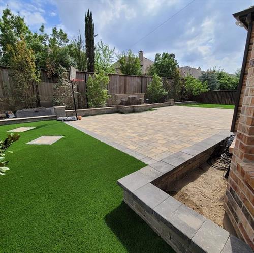 Backyard completely remodeled. convention of pavers,travertines,synthetic grass,water feature and seat walls.