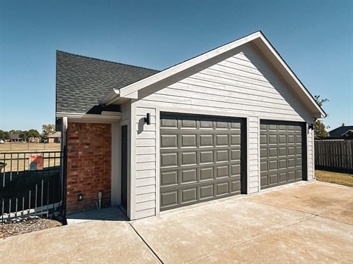 Shop remodel where we extended the front approximately 4' out and framed the roof higher to allow for a lift to be installed.