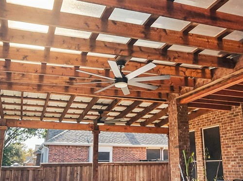 Cedar pergola with a poly carbonate roofing system and electrical accessories.
