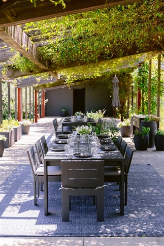 The restored Long Barn offers an enchanting setting for a private outdoor wine tasting overlooking the historic buildings and old vines.