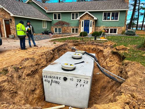 Septic tank in front of green home