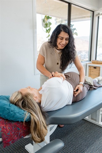 Dr. Ayat delivering a chiropractic adjustment for a low back pain patient