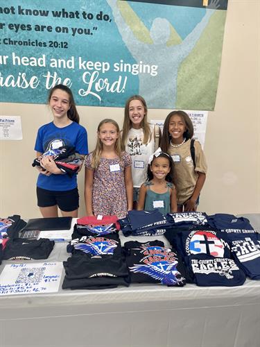 Eighth Graders and their Helpers Selling TCCS Merchandise During the Open House