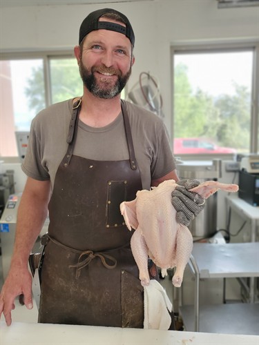 Bradley prepping to part a chicken.