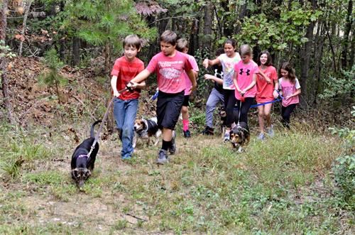 Children of all ages serve others in the community. Some classes "adopt" a non-profit, and here our 5th graders are walking pups at the local shelter.