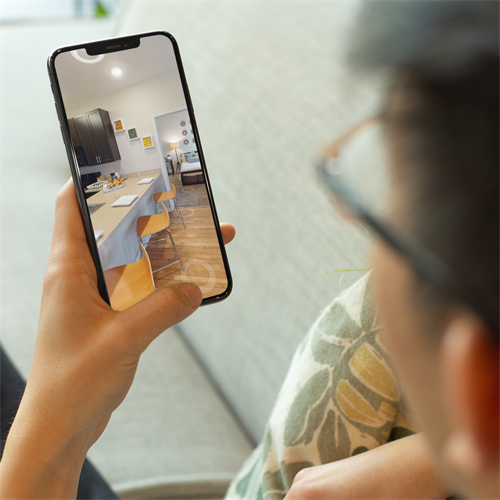 Gallery Image over-the-shoulder-mockup-of-a-man-with-glasses-checking-his-iphone-xs-25534.png