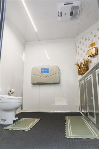 Woman’s bathroom with diaper changing station 