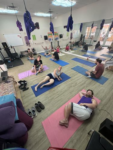 Promise residents doing yoga in fitness room