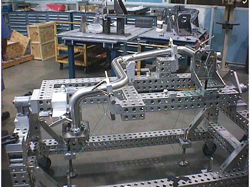 Boeing/Rocketdyne (Canoga Park, CA) RS68 LOX fixture with trunnion for rotation and ergonomic assembly. All large fixtures using AMT 40, our robust system for large part accuracies and capabilities. Boeing/Rocketdyne (Canoga Park, CA) RS68 LOX fixture with trunnion for rotation and ergonomic assembly. All large fixtures using AMT 40, our robust system for large part accuracies and capabilities.