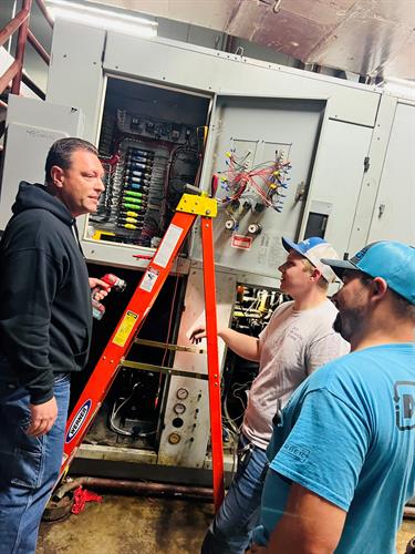 Service team working on pool equipment at a local high school