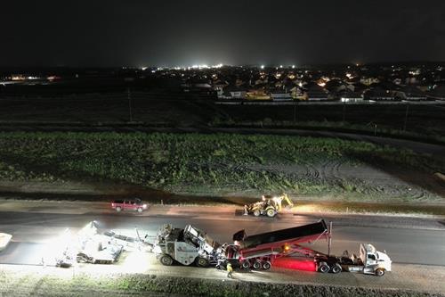 Placing asphalt on one of our projects at night to avoid traffic interruption 