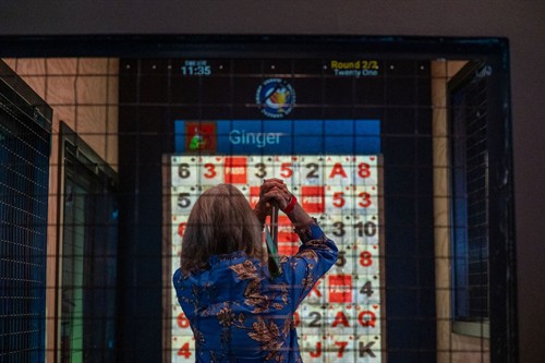 Targets and games are projected onto wood in axe throwing lanes