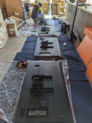 TVs being prepped with custom ceiling mounts TVs being prepped with custom ceiling mounts