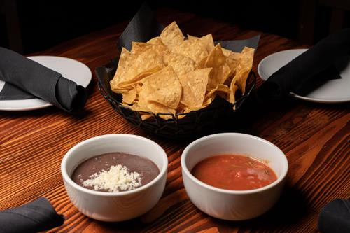 chips, salsa, black bean dip with cotija cheese 