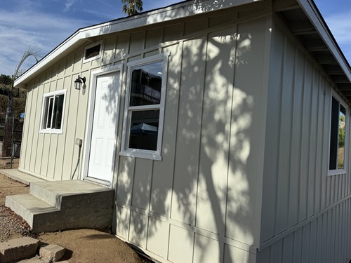 A deteriorated 1920s garage and shop was structurally rehabilitated and transformed into a modern one-bedroom ADU while preserving the existing building, including its substantial old-growth framing.