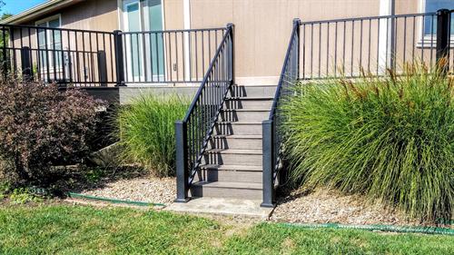 Capped Composite decking and railing along the back of a house in Kansas