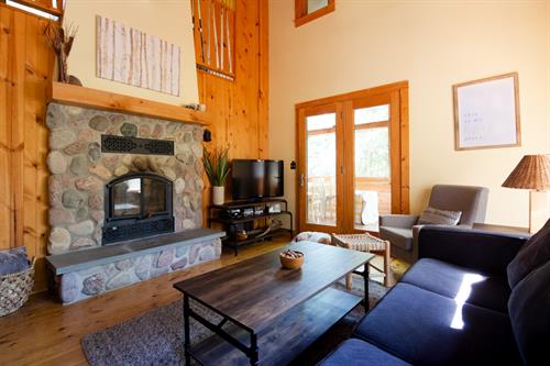 A beautiful, wood-burning, stone fireplace sets the stage in the large-windowed living room. In the winter, warm-up to the sound of a crackling fire after a day of skiing or snowshoeing. A beautiful, wood-burning, stone fireplace sets the stage in the large-windowed living room. In the winter, warm-up to the sound of a crackling fire after a day of skiing or snowshoeing.