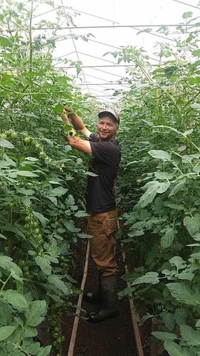 Chris Duke from Great Oak Farm in Mason, WI enjoys an afternoon in the hoophouse.