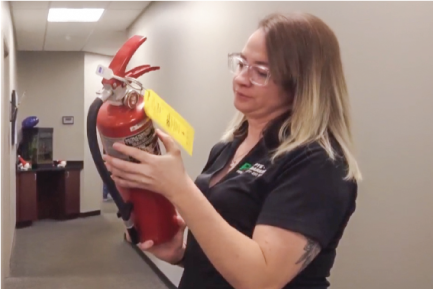 Technician performs extinguisher inspection